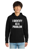 A man wearing a black pullover hoodie with the text 'I IDENTIFY AS A PROBLEM' printed in bold white capital letters on the front, paired with light blue jeans, against a plain white background.