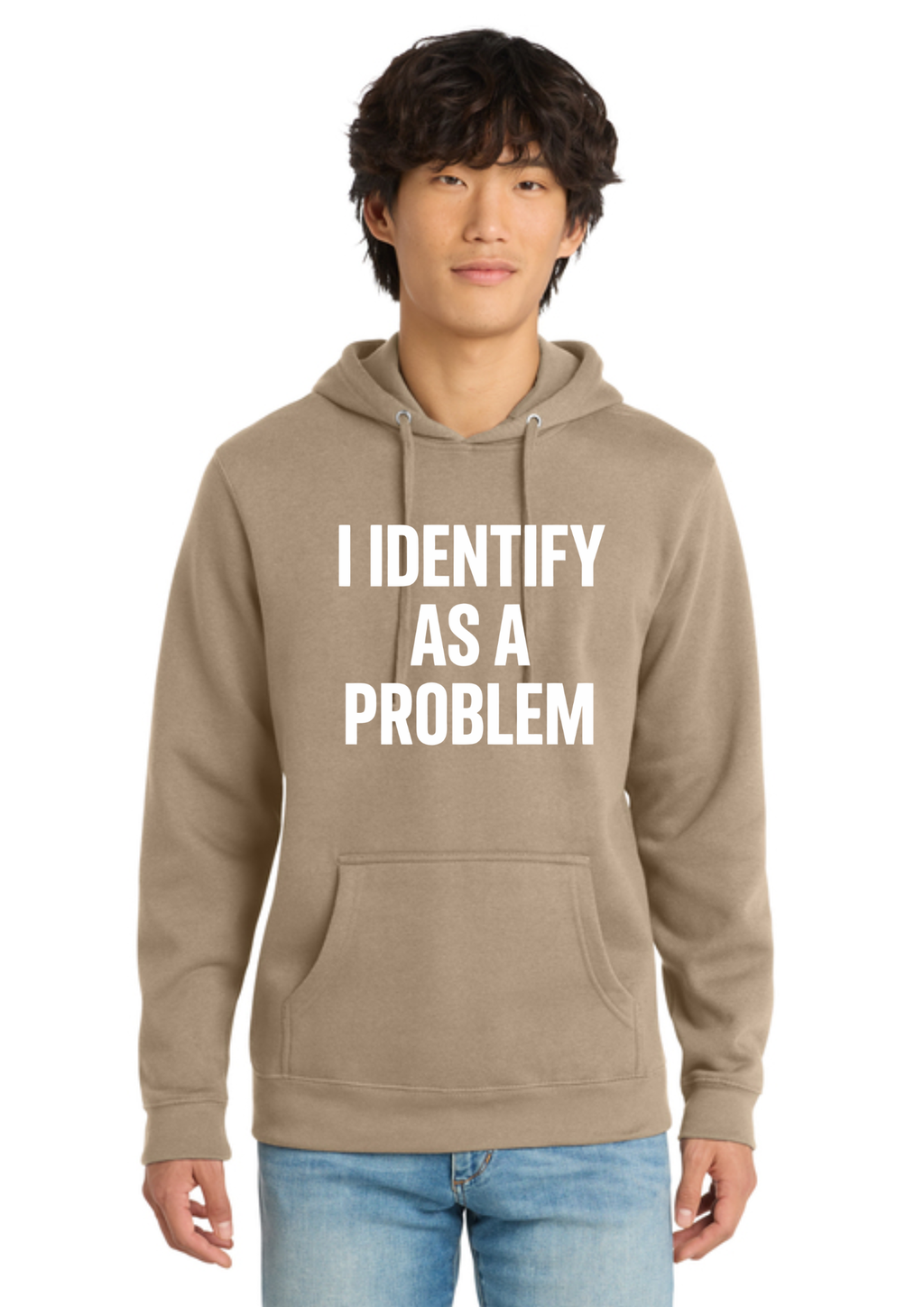 A man wearing an olive green pullover hoodie with the text 'I IDENTIFY AS A PROBLEM' printed in bold white capital letters across the chest, paired with light blue jeans, set against a plain white background.