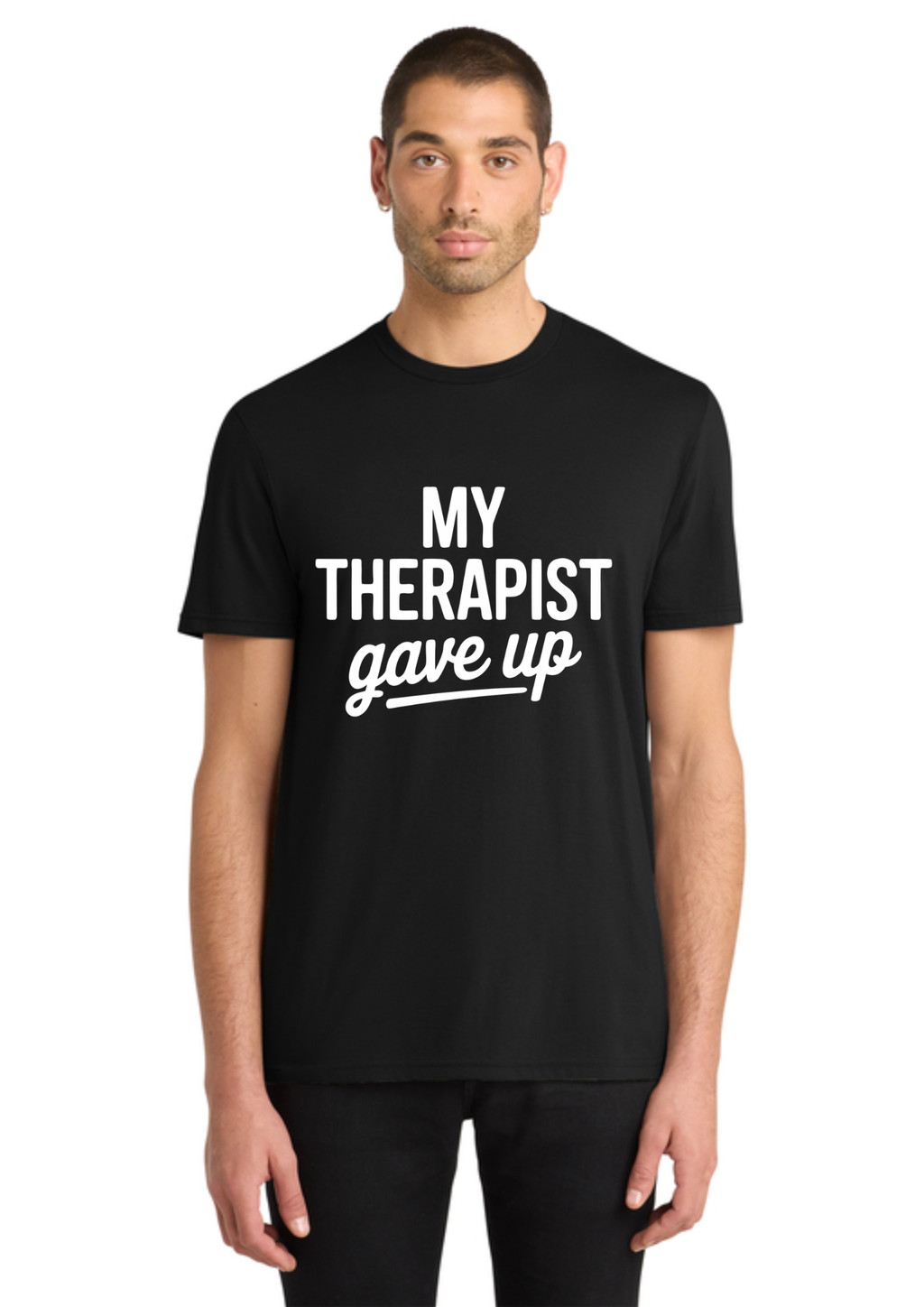 A man wearing a black short-sleeve t-shirt with the white printed text 'MY THERAPIST gave up' on the chest, standing against a plain white background.