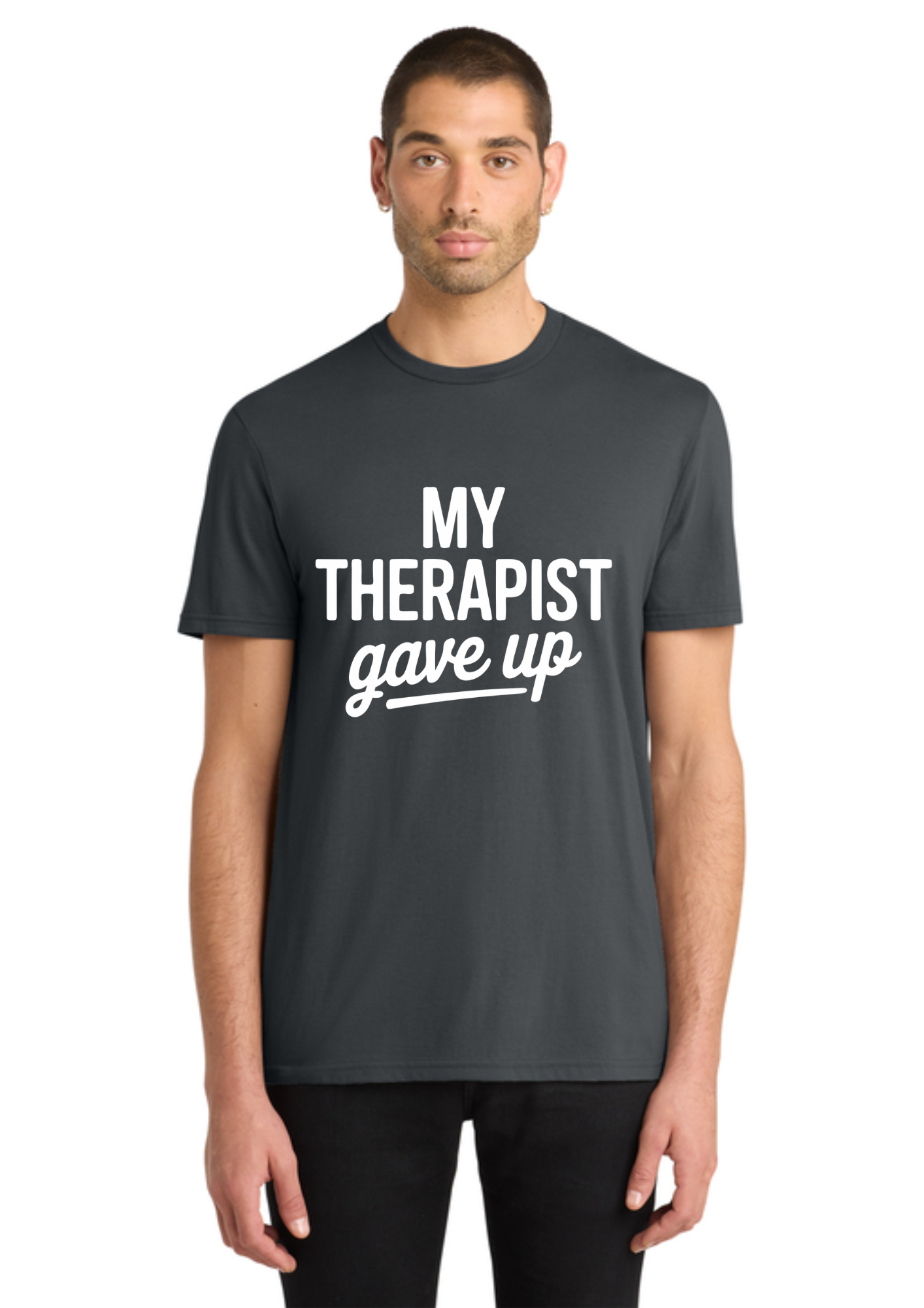 A man wearing a dark gray crewneck t-shirt with the white printed text 'MY THERAPIST gave up' on the chest, standing against a plain white background.